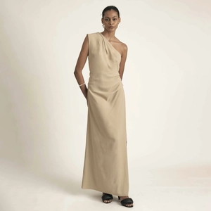 Elegant beige one-shoulder maxi dress with pleated waist and minimalist draped silhouette