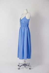 Close-up of light blue camisole dress with ruffle neckline and elastic waist on a mannequin