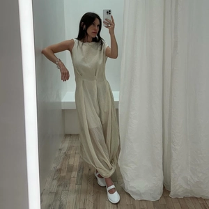 Minimalist beige backless maxi dress with knot detail and irregular silhouette in summer style