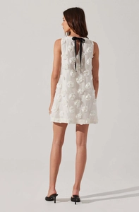 Detail of 3D rose flower appliques and black satin bow on sleeveless mini dress