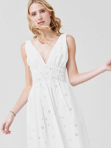 Detailed close-up of white deep V-neck dress featuring delicate eyelet embroidery textures