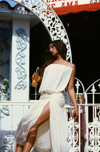 Detail of off-white strapless dress featuring waist pleats and high slit design