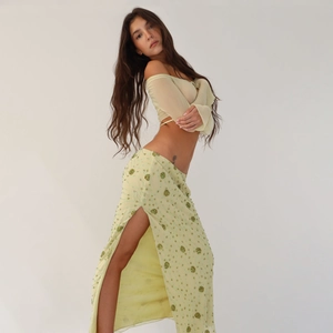 Elegant two-piece set with off-shoulder sheer top and sequined side slit maxi skirt