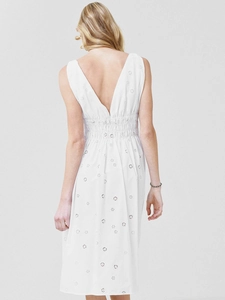 Detail of white eyelet dress showing back deep V-neck and smocked waist design
