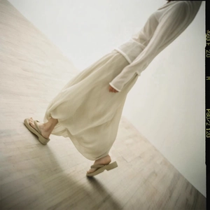 Minimalist summer backless knot dress with sheer long sleeve top and beige platform sandals