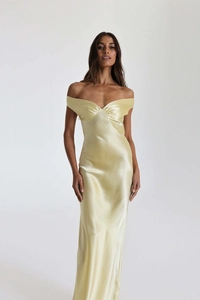 Detailed close-up of the elegant off-shoulder pleated neckline on the champagne satin dress