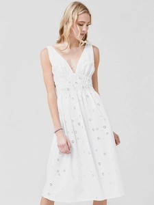 Close-up of white V-neck dress featuring delicate floral embroidery and eyelet details