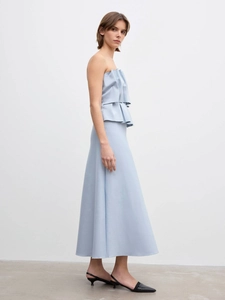 Detail showing light blue two-piece set with pleated bandeau top and long maxi skirt