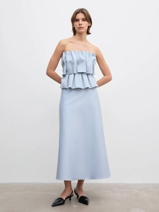 Detail of light blue strapless peplum top and long skirt with pleated layered ruffles