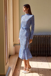 Close-up of the delicate light blue lace texture and embroidery on this long-sleeved dress
