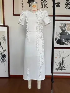 Detail of elegant white V-neck party dress with ruffle sleeves and vertical frills