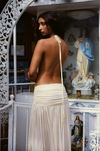 Detail of cream backless halter dress showing pleated waist and metal bead ties