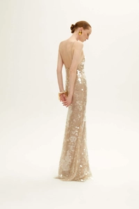 Detailed back view of backless champagne evening gown with silver sequins and slim straps