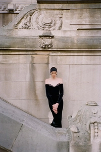 Close-up of elegant black velvet evening dress featuring lace off-shoulder neckline details