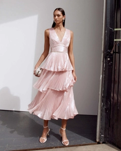 Detail of pink metallic tiered pleated dress with deep V-neck and ruffled skirt texture