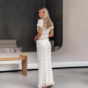 White pleated two-piece set for women featuring a ruffle top and tiered maxi skirt