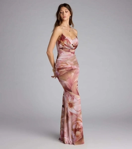 Close-up of floral print textures and pleated fabric on a slim mermaid evening dress
