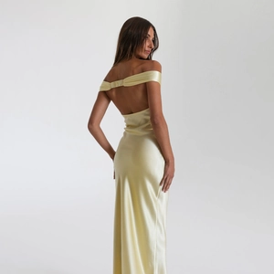 Elegant pale yellow satin maxi dress with off-shoulder neckline and open back design