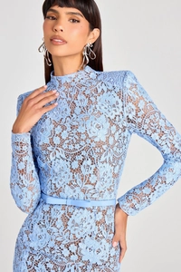Macro shot of light blue lace gown showing intricate floral texture and bow waistband