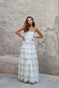 Detail of light blue tiered lace maxi dress featuring delicate layered embroidery patterns