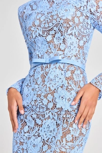 Close-up of light blue lace dress detailing featuring waist belt and floral embroidery