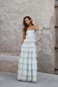 Detailed view of embroidery lace and layered ruffle hem on floral cake dress