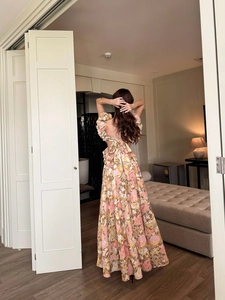Close-up of a floral dress back featuring a large bow tie and open back detail