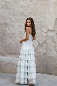 Detailed view of light blue tiered lace dress with intricate embroidery and delicate ruffles