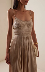 Detailed view of champagne gold pleated maxi dress with elegant spaghetti straps and satin finish