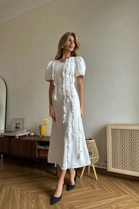 Elegant white mid-length party dress with puff sleeves and ruffled trim detail