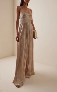 Detailed view of the fine champagne pleats and silky texture on the backless formal dress