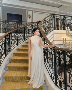 Detail of elegant satin evening dress with high neck and flowing back cape design