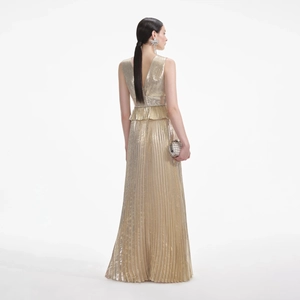 Macro shot of metallic pleated fabric texture and ruffled peplum waist detail on evening gown