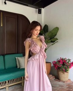 Detailed close-up of pink-purple floral dress with deep V-neck and ruffle trim accents