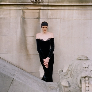 Elegant black velvet off-shoulder evening gown with lace details and long sleeves
