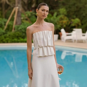 Elegant white strapless pleated dress with ruffles for formal evening parties