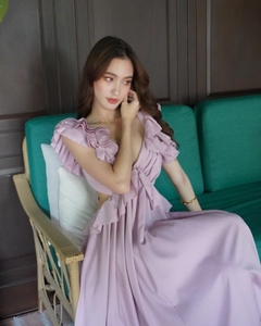 Detail of ruffled shoulders and deep V-neckline on a floral mauve evening maxi dress