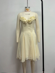 Detail of 3D floral appliqués on cream evening dress with layered wavy skirt
