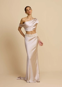 Detailed close-up of champagne satin evening dress with intricate white lace embroidery