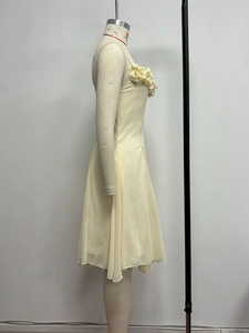 Detailed view of cream evening dress with 3D floral appliques and V-neck chiffon fabric