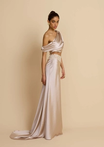 Detailed view of champagne satin asymmetrical top with elegant lace waist and long train skirt