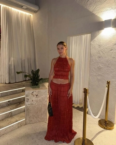 Detail of pleated rust red halter top and long skirt set for parties and vacations