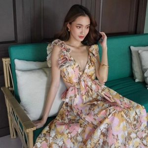 Floral maxi dress with deep V-neck, ruffle shoulders, and side waist cut-outs for summer