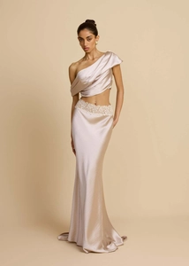 Detailed view of champagne satin gown with white lace trim on the high waist skirt