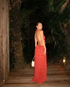 Close-up of pleated burnt orange halter top and layered maxi skirt for summer vacations