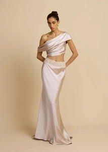 Detail of champagne pink satin dress set with white lace trim and asymmetrical design