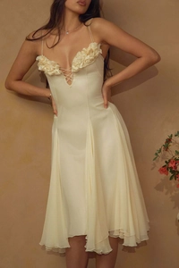 Detail of cream evening dress with 3D floral appliques and lace-up V-neckline