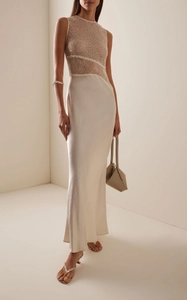 Detail of ivory lace patchwork and sequin embroidery on an elegant evening gown