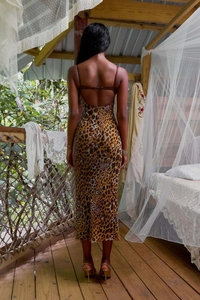 Close-up of sexy open back leopard print dress with sequins on a tropical terrace