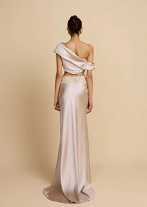 Back view of champagne satin evening gown with lace detail and one-shoulder top